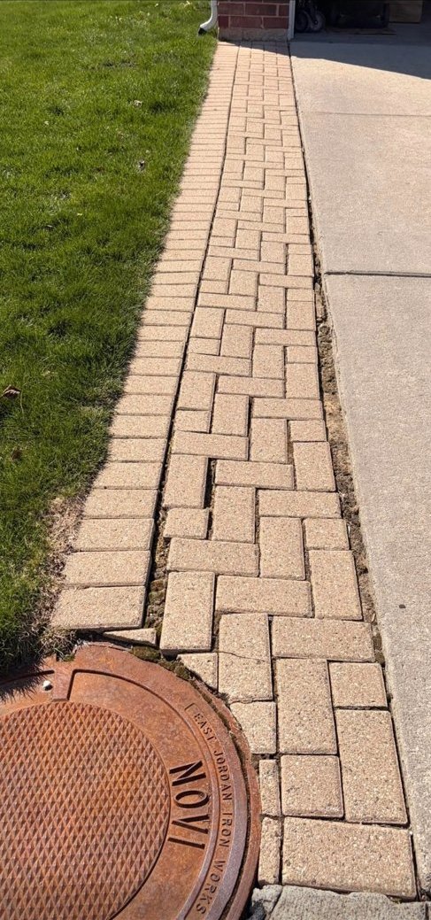 Misaligned, drifting pavers with widening gaps